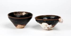Two Chinese Temoku glazed tea bowls, each one with a brown black glaze, with coral encrustations, Southern Song 1127-1279, 11.2cm diameter