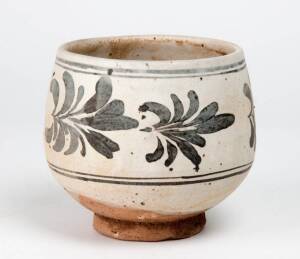 A Chinese Cizhou deep stoneware bowl, Yuan Dynasty, 14th century, painted with floral motif in iron-brown. 12.7cm high, 12.2cm diameter