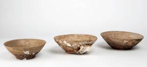 Three Chinese stoneware bowls, with proto-celadon glazes and coral adhering to the surface, late Tang Dynasty, 9th century, from a shipwreck. 17.5cm, 20.8cm and 20.4cm diameter