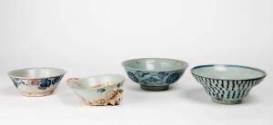 Four Chinese blue and white bowls, late Ming Dynasty, two shipwreck bowls with coral attached, 18.4cm, 17.5cm, 14.4cm and 13.5cm diameter
