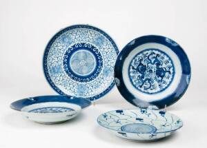 Four Chinese blue and white dishes, 18th and early 19th century, including two with dragons, both marked, one with seven character under the base and one with a potter&rsquo;s mark. 23.6cm, 20.8cm, 20.3cm and 18.9cm diameter