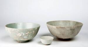 Two pale green glazed deep bowls and a small cup, Binh Thuan Shipwreck 42112, late Ming Dynasty, early 17th century. 19cm, 21.5cm and 7.4cm diameter