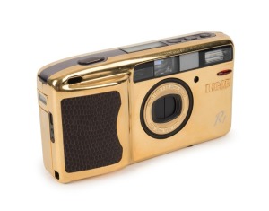 RIKEN OPTICAL: Gold-body Ricoh R1 35mm camera [#EQ137296] with leatherette insert, circa 1994. Presented in maker's box with instruction booklet and leatherette pouch.