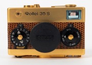 FRANKE & HEIDECKE: 1979 Rollei 35S compact camera [#0046/1500], in gold-plated edition marking the 60th anniversary of the Rollei company. In addition to being plated in 24-carat gold, the body is covered in lizard skin, bearing a uniquely numbered plate - 2