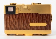 FRANKE & HEIDECKE: 1979 Rollei 35S compact camera [#0046/1500], in gold-plated edition marking the 60th anniversary of the Rollei company. In addition to being plated in 24-carat gold, the body is covered in lizard skin, bearing a uniquely numbered plate - 3