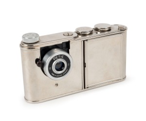 WALTER KUNIK: Petie Vanity subminiature camera for 14x14 exposures on 16mm film, circa 1956, with all-chrome body. Front door opens to reveal mirror and space for powder pad.