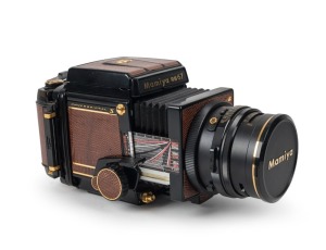 MAMIYA: Mamiya RB67 Pro-S gold-plated and lizardskin-covered SLR camera [#C229033], circa 1982, with Mamiya-Sekor C 90mm f3.8 lens [#141484] and front lens cap, together with maker's box, instruction booklet, and wrist strap. 300 of these cameras were iss