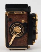 FRANKE & HEIDECKE: Rolleiflex&nbsp;2.8F 1983 Aurum Edition gold-plated commemorative TLR&nbsp;camera [#8300420], with Xenotar&nbsp;and&nbsp;Heidosmat&nbsp;80mm f2.8 lenses and&nbsp;alligator-leather covering. Presented in wooden maker's box with leather wrist strap. - 5
