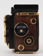 FRANKE & HEIDECKE: Rolleiflex&nbsp;2.8F 1983 Aurum Edition gold-plated commemorative TLR&nbsp;camera [#8300420], with Xenotar&nbsp;and&nbsp;Heidosmat&nbsp;80mm f2.8 lenses and&nbsp;alligator-leather covering. Presented in wooden maker's box with leather wrist strap. - 6