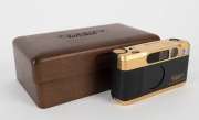 YASHICA: 1992 limited-edition Contax T2 60th Anniversary gold and black compact 35mm camera [#M-0001], in original timber and silk-lined presentation box, with leather case and straps. - 2