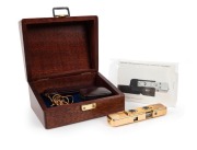 MINOX: 1988 limited-edition Minox LX Gold sub-miniature camera [#820-999]. Presented in original lined timber box with leather camera case, flash attachment in separate leather case, gold chain, and documentation. One of 999 such cameras produced to celeb