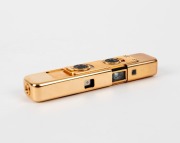 MINOX: 1988 limited-edition Minox LX Gold sub-miniature camera [#820-999]. Presented in original lined timber box with leather camera case, flash attachment in separate leather case, gold chain, and documentation. One of 999 such cameras produced to celeb - 2