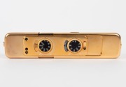 MINOX: 1988 limited-edition Minox LX Gold sub-miniature camera [#820-999]. Presented in original lined timber box with leather camera case, flash attachment in separate leather case, gold chain, and documentation. One of 999 such cameras produced to celeb - 5