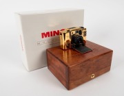 MINOX: 1992 Minox 35mm M.D.C. Gold Special-Edition compact camera [#7800555] with 24-carat gold-plated aluminium body, presented in original timber presentation case, together with maker's box, instruction booklet, and inspection certificate. One of only - 2