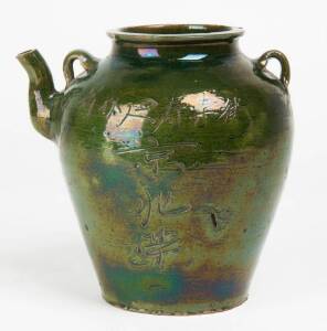 A Chinese green glazed stoneware ewer with inscription, 18.6cm high