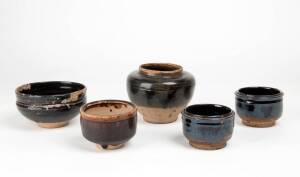 Four Chinese dark brown glazed bowls and a jar, largest 10cm high and largest bowl 10.3cm diameter