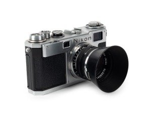 NIPPON KOGAKU: Circa 1956 Nikon S2 rangefinder camera [#6191136], with chrome-body and black dials, Nikkor-S·C 50mm f1.4 lens [#389561], and snap-on Nippon Kogaku lens hood.