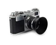 NIPPON KOGAKU: Circa 1956 Nikon S2 rangefinder camera [#6191136], with chrome-body and&nbsp;black dials,&nbsp;Nikkor-S&middot;C&nbsp;50mm f1.4 lens [#389561], and snap-on Nippon Kogaku&nbsp;lens hood.