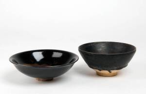Two Chinese black glazed bowls, one with a moulded fish, largest 16.2cm diameter