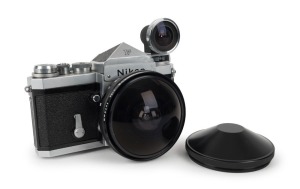 NIPPON KOGAKU: Nikon F SLR camera [#7036896], circa 1969, with Fish-eye-Nikkor 75mm f5.6 lens [#750727] and Nikkor Fish-eye viewfinder [#388813], together with plastic lens caps.