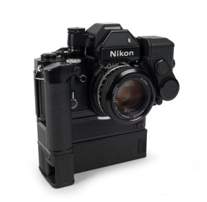 NIPPON KOGAKU: Black-body Nikon F2S Photomic SLR camera [#F2 7751700], circa 1975, fitted with Nikkor 50mm f1.4 lens [#4056832], Nikon aperture control, Nikon MD-3 motor drive, and MB-2 battery pack.