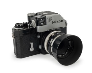 NIPPON KOGAKU: Black-body Nikon F Photomic T SLR camera [#6974497], circa 1969, with Nikkor-S Auto 50mm f2 lens [#582673], Photomic T finder, and Nikkor 50/2 F lens hood.