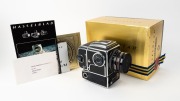 HASSELBLAD: 1979 Hasselblad 500EL/M '10 Years on the Moon' limited-edition medium-format SLR camera [#UR 1313243] in black and chrome, with Planar 80mm f2.8 lens [#5909527] and Synchro-Compur shutter, together with front lens cap and power cable. Presente - 3