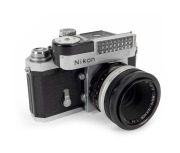 NIPPON KOGAKU: Early production 1960 Nikon F&nbsp;SLR camera [#6414686], with Micro-Nikkor&nbsp;55mm f3.5 lens [#173210], rear lens cap, and waist-level viewfinder attachment.