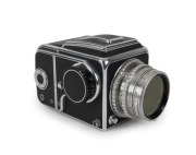 HASSELBLAD: Hasselblad 1600F medium-format SLR camera [#CH 12702 & #CH 14224] in black and chrome, circa 1952, with Ektar 80mm f2.8 lens [#RY263], Hasselblad-Y 1.5-50 lens filter, and carry strap.