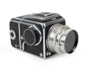 HASSELBLAD: Hasselblad 1000F medium-format SLR camera [#CT 20461 & #CT 27829] in black and chrome, circa 1956, with Tessar 80mm f2.8 lens [#587778] and lens filter.