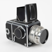 HASSELBLAD: Hasselblad 1000F medium-format SLR camera [#CT 20461 & #CT 27829] in black and chrome, circa 1956, with Tessar 80mm f2.8 lens [#587778] and lens filter. - 2