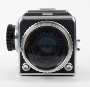 HASSELBLAD: Hasselblad 1000F medium-format SLR camera [#CT 20461 & #CT 27829] in black and chrome, circa 1956, with Tessar 80mm f2.8 lens [#587778] and lens filter. - 5