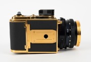 HASSELBLAD: 1985 Hasselblad 2000FC/M '100 Years in Photography' limited-edition medium-format SLR camera [#RI 1520698 & #RI 3264751] in black and gold, with Planar 80mm f2.8 lens [#5872721]. Bears a plaque indicating that this camera is number 227 of 1500 - 2