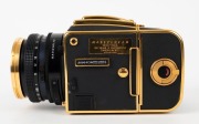 HASSELBLAD: 1985 Hasselblad 2000FC/M '100 Years in Photography' limited-edition medium-format SLR camera [#RI 1520698 & #RI 3264751] in black and gold, with Planar 80mm f2.8 lens [#5872721]. Bears a plaque indicating that this camera is number 227 of 1500 - 5