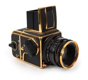 HASSELBLAD: 1987 Hasselblad 500C/M 'Gold Exclusive' limited-edition medium-format SLR camera [#RT 1401214 & #RT 3301879] in black and gold, with Planar 80mm f2.8 lens [#6953169]. Presented in maker's box with certificate of authenticity, instruction bookl