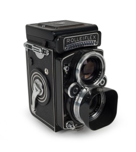 FRANKE & HEIDECKE: Rolleiflex 2.8F TLR camera [#2437235], circa 1963, with Planar 80mm f2.8 lens [#3939604] and Synchro-Compur shutter, with metal lens hood in leather maker's pouch.