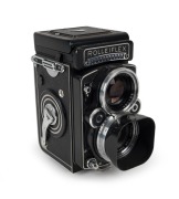 FRANKE & HEIDECKE:&nbsp;Rolleiflex&nbsp;2.8F&nbsp;TLR&nbsp;camera [#2437235], circa 1963, with Planar 80mm f2.8 lens [#3939604] and&nbsp;Synchro-Compur&nbsp;shutter, with metal lens hood in leather maker's pouch.