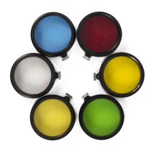 LEITZ: Set of six circa 1931 Leica A36 lens filters - one FIOLOA UVa, one FEOOG dark red, one FIGRO light yellow, one FIGAM medium yellow, one FIPOS green, and one BQCOO blue. (6 items)