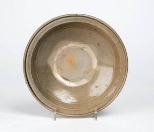 A Chinese celadon glazed dish, probably Yuan Dynasty, 13th/14th century, 18.8cm diameter, Museum label attached