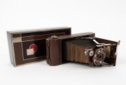 KODAK: Gift No. 1A vertical-folding camera, circa 1930, in brown leather, decorated with metal Art-Deco inlay on front door. Presented in original cedar box, which repeats the beautiful Art-Deco design present on the camera itself. - 2