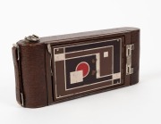 KODAK: Gift No. 1A vertical-folding camera, circa 1930, in brown leather, decorated with metal Art-Deco inlay on front door. Presented in original cedar box, which repeats the beautiful Art-Deco design present on the camera itself. - 3