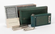 KODAK: Vanity Kodak Ensemble vertical-folding camera [#34553] in green finish, circa 1928, complete with original lipstick, powder compact, mirror, and money pocket in leather case with strap, together with instructions, original owner's card, and maker's - 3