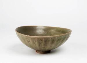A Chinese Longquan fluted celadon bowl, Yuan Dynasty, 14th century, 20.5cm diameter irregular