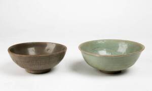 Two Longquan celadon bowls, Yuan Dynasty, 14th century one incised on the inside and with a pale blue glaze, 18.5 and 17.2cm diameter