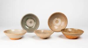 Five celadon glazed shallow bowls, Yuan/Ming Dynasty 14th/15th century, largest 16cm diameter, each with an unglazed firing ring in the middle
