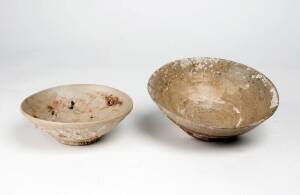 Two Southern Chinese celadon bowls, encrusted with coral, Tang and Yuan Dynasty, 10th and 14th century, 20.7cm and 17cm diameter