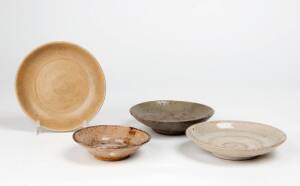 Four Chinese small celadon glaze dishes, 14th/15th century, largest 13.8cm diameter