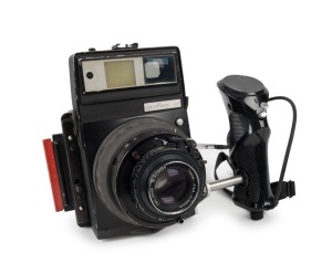 GRAFLEX: US-military version XLRF KS-98B medium-format rangefinder camera [#X 50725], circa 1965, with Tessar 100mm f3.5 lens [#4238966] and Synchro-Compur shutter, together with three-frame finder, Polaroid instant pack film holder, and hand grip attachm