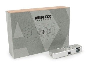 MINOX: Minox AX limited-edition subminiature camera [#AX.324], circa 1992, complete in original wooden box with leather case, wrist chain, warranty card, quality control receipt, and instruction booklet. Number 324 in a limited edition of 500.