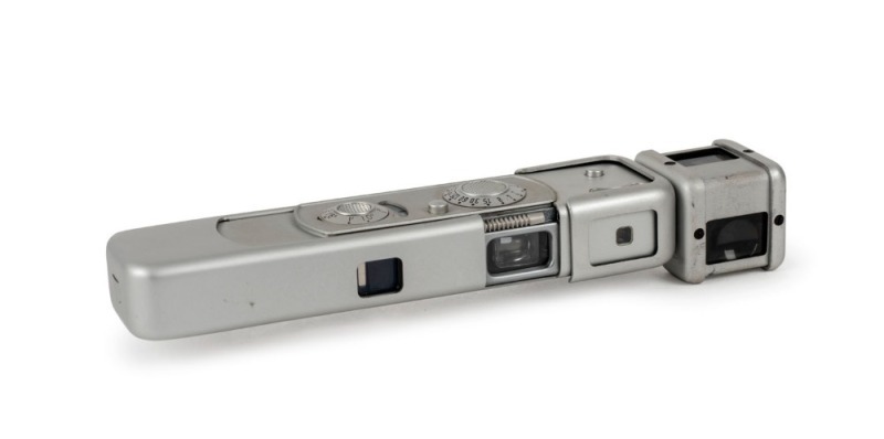 MINOX: Chrome-body Minox BL subminiature camera [#1 209 907], circa 1972, with Minox 15mm f3.5 lens and waist-level finder attachment.